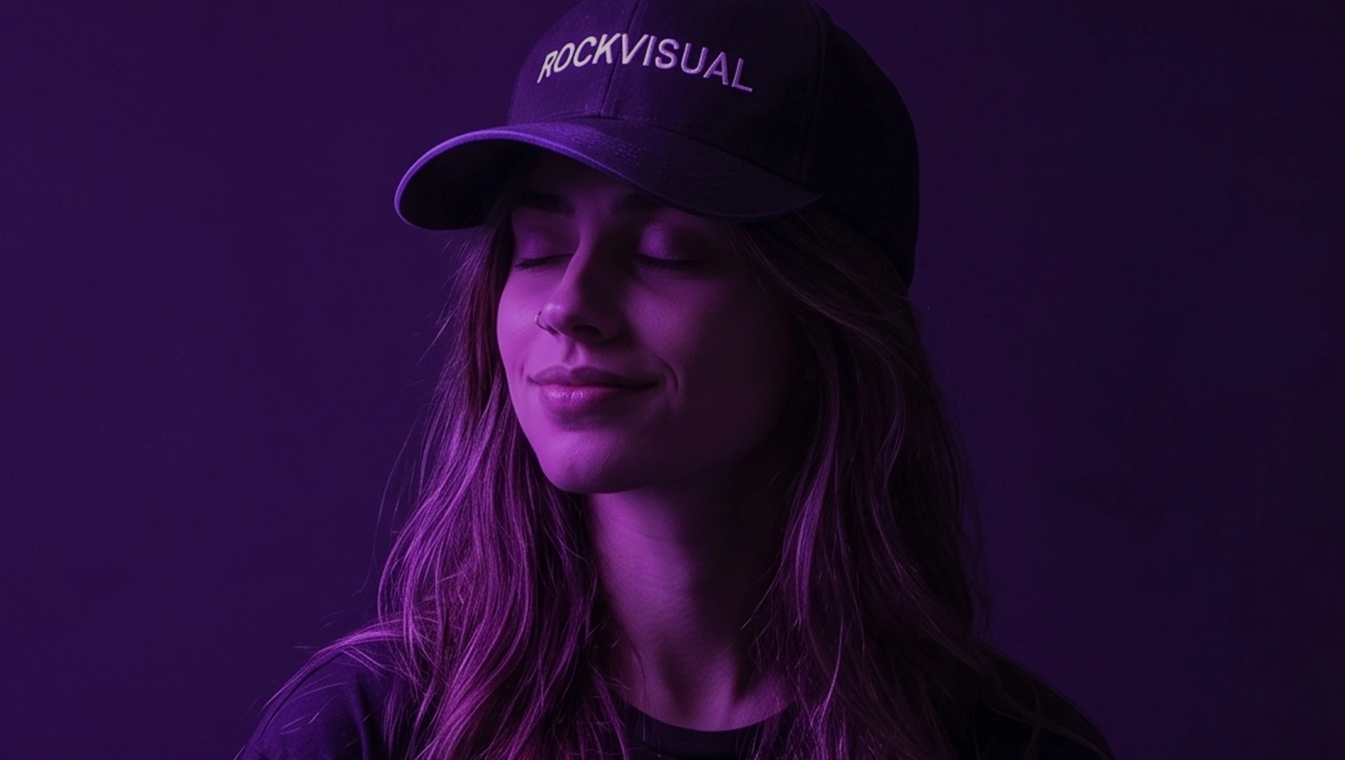 Portrait in signature Rockvisual cap under purple studio light